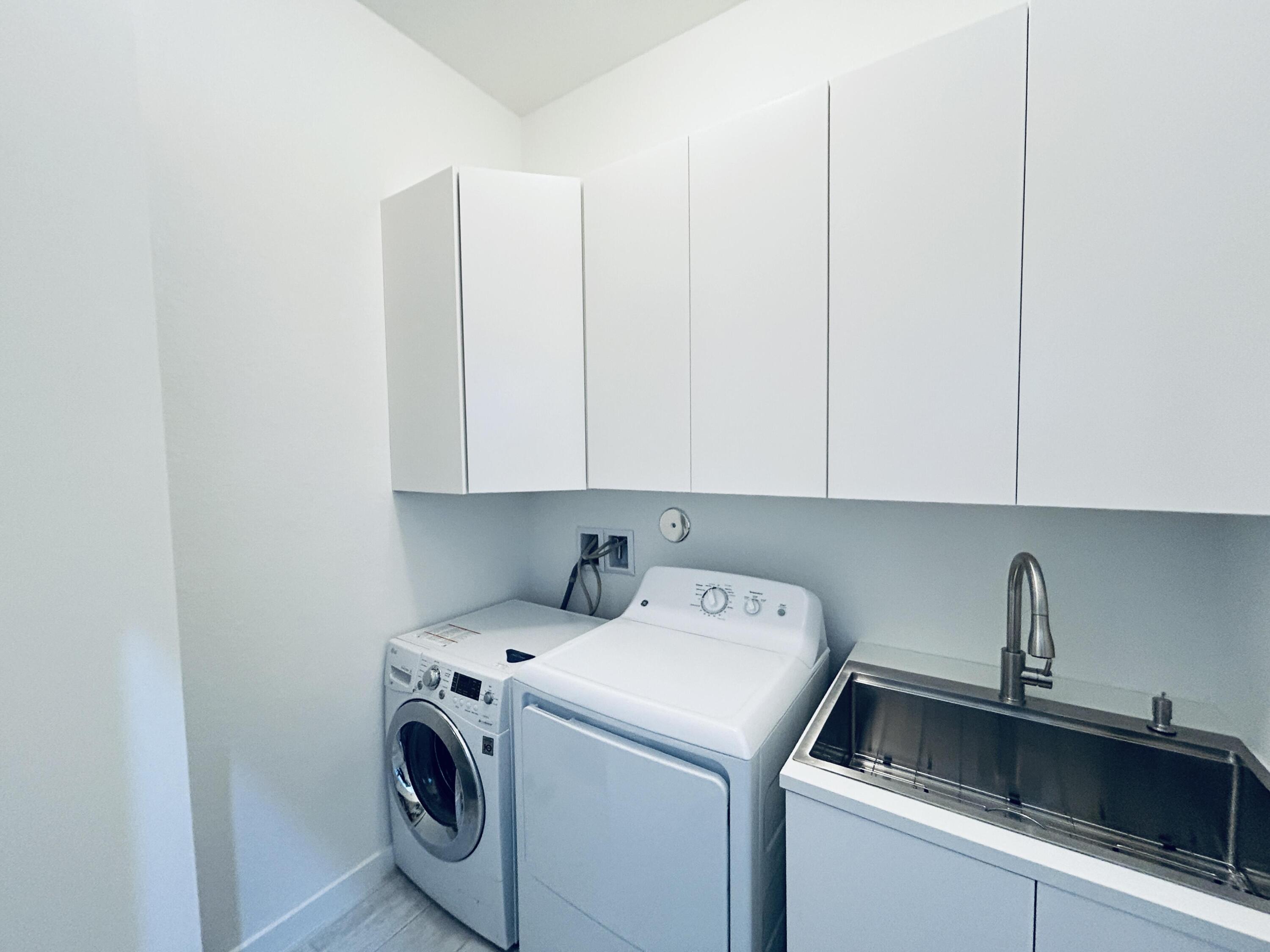 19567 Weathervane Way Loxahatchee, FL 33470 - Photo 22 of 49 a utility room with dryer and washer