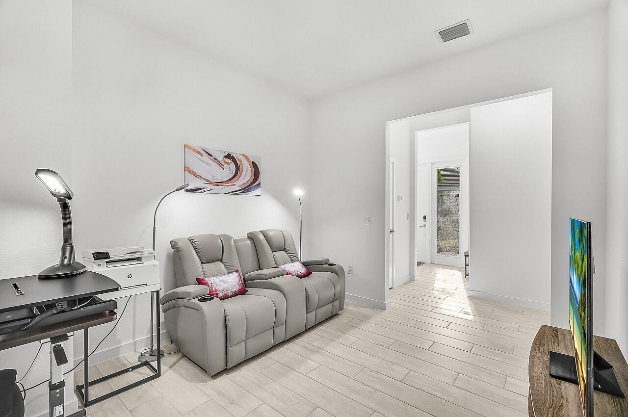 19567 Weathervane Way Loxahatchee, FL 33470 - Photo 24 of 49 a bedroom with bed and a flat tv screen on dresser