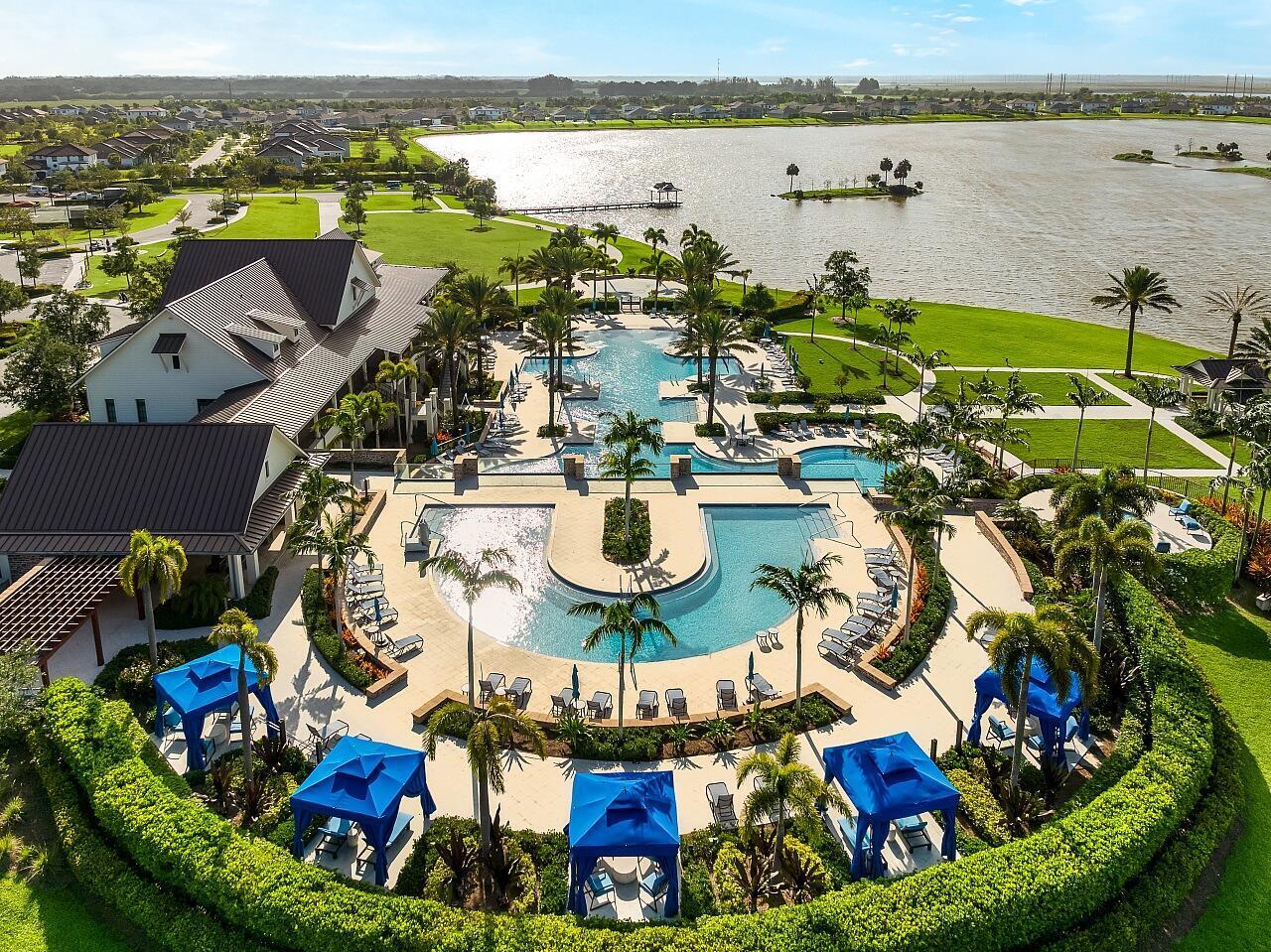 19567 Weathervane Way Loxahatchee, FL 33470 - Photo 37 of 49 a view of a swimming pool with outdoor seating and lake view