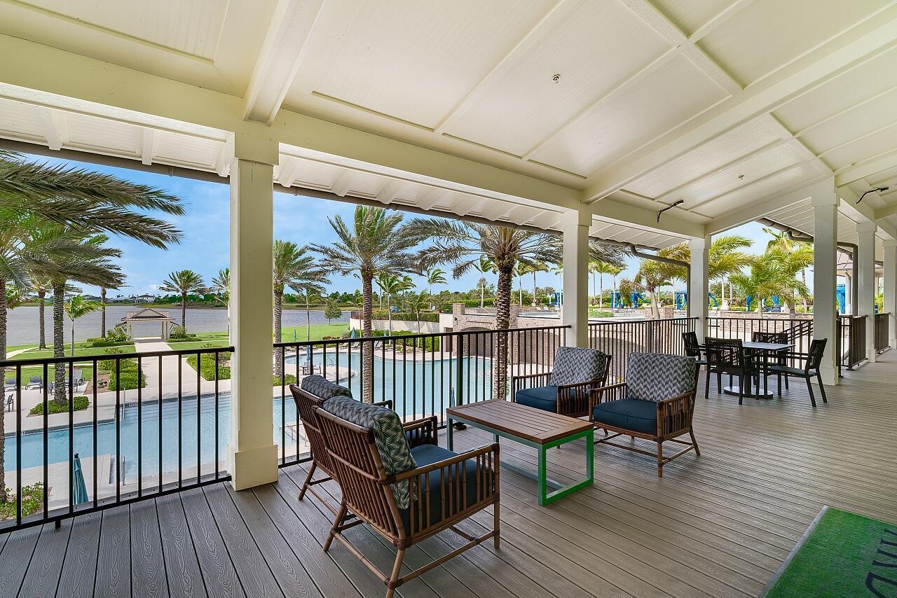 19567 Weathervane Way Loxahatchee, FL 33470 - Photo 39 of 49 a view of a chairs and table in patio with wooden floor