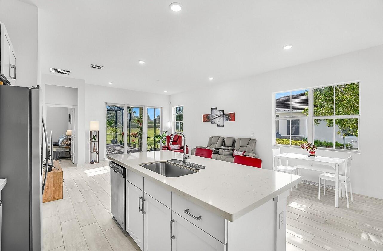 19567 Weathervane Way Loxahatchee, FL 33470 - Photo 8 of 49 a kitchen that has a lot of counter space and a sink