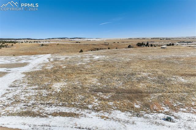15770 Atlas Loop Peyton, CO 80831 - Photo 3 of 10 Yard layered in snow featuring a rural view