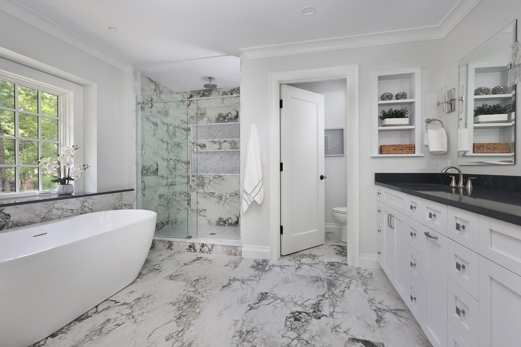 194 Hobart Road Newton, MA 02467 - Photo 19 of 37 a bathroom with a bathtub sink and mirror