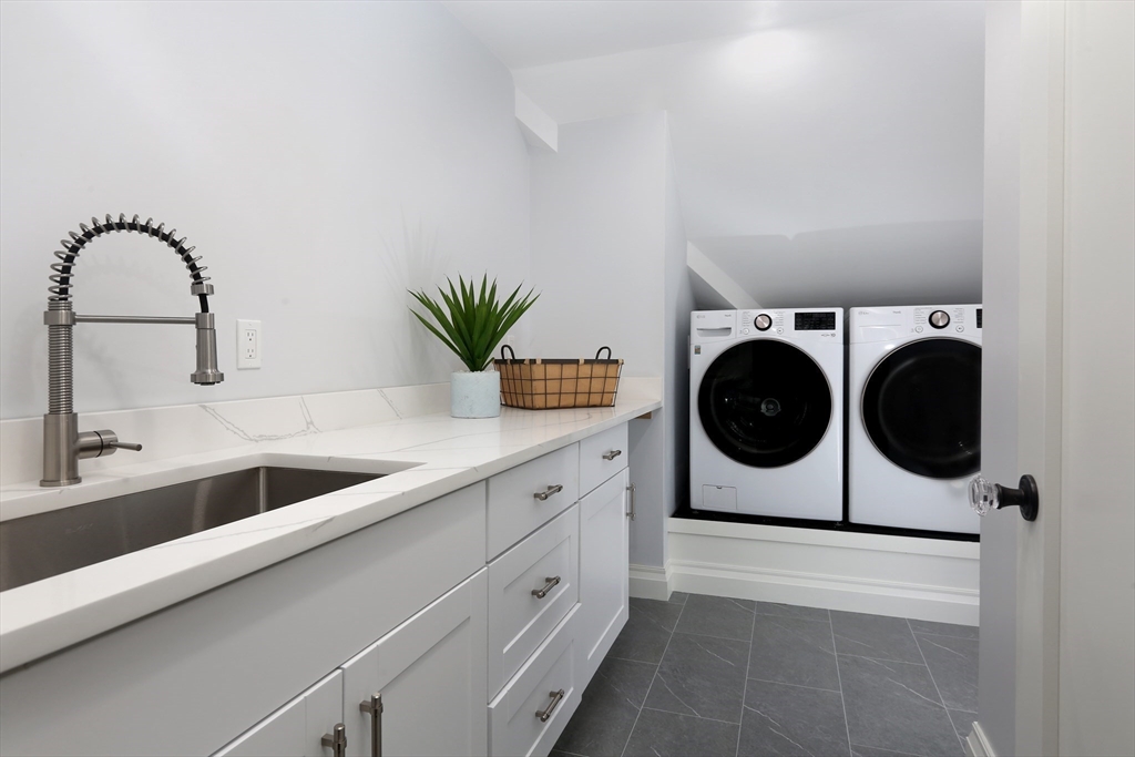 194 Hobart Road Newton, MA 02467 - Photo 28 of 37 a kitchen with a sink and a stove with wooden floor