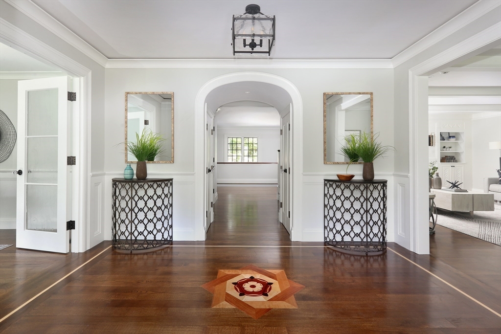 194 Hobart Road Newton, MA 02467 - Photo 4 of 37 a view of a hallway with wooden floor and furniture