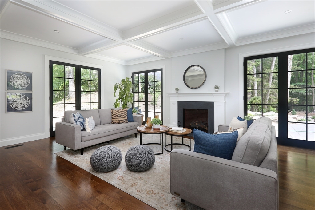 194 Hobart Road Newton, MA 02467 - Photo 7 of 37 a living room with furniture a large window and a fireplace