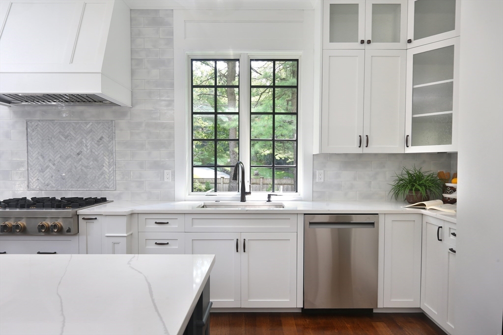 194 Hobart Road Newton, MA 02467 - Photo 8 of 37 a kitchen with stainless steel appliances white cabinets and a window
