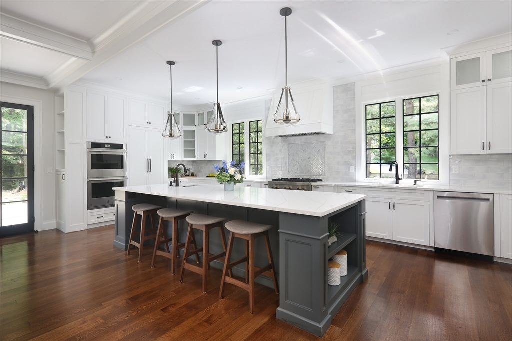 194 Hobart Road Newton, MA 02467 - Photo 10 of 37 a kitchen with a sink a stove a dining table and chairs