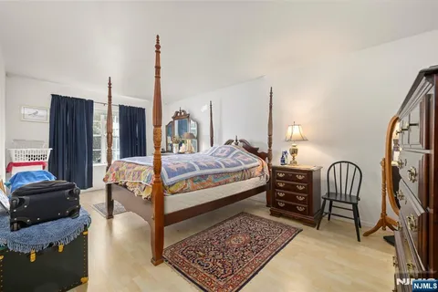 a bedroom with furniture and a rug