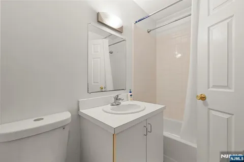 a bathroom with a sink toilet and a mirror