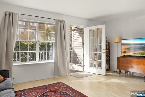 a bedroom with a bed and a large window with outer view