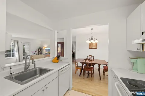 a kitchen with a sink and chairs