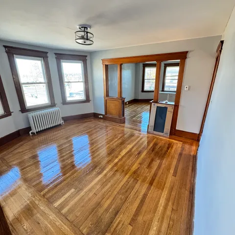 wooden floor with windows and hardwood floor