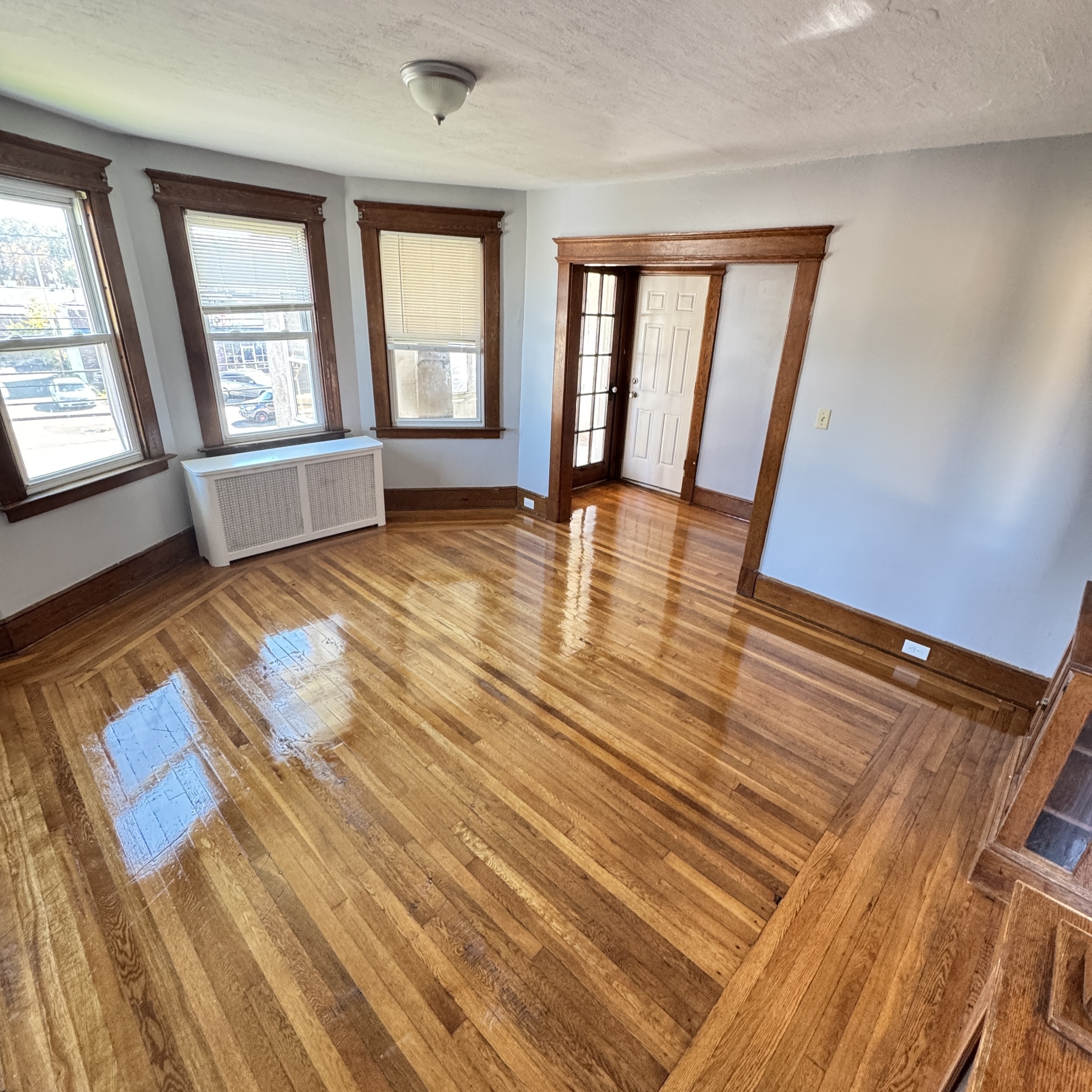 1528 Dixwell Avenue, Unit 2 Hamden, CT 06514 - Photo 2 of 11 an empty room with wooden floor and windows
