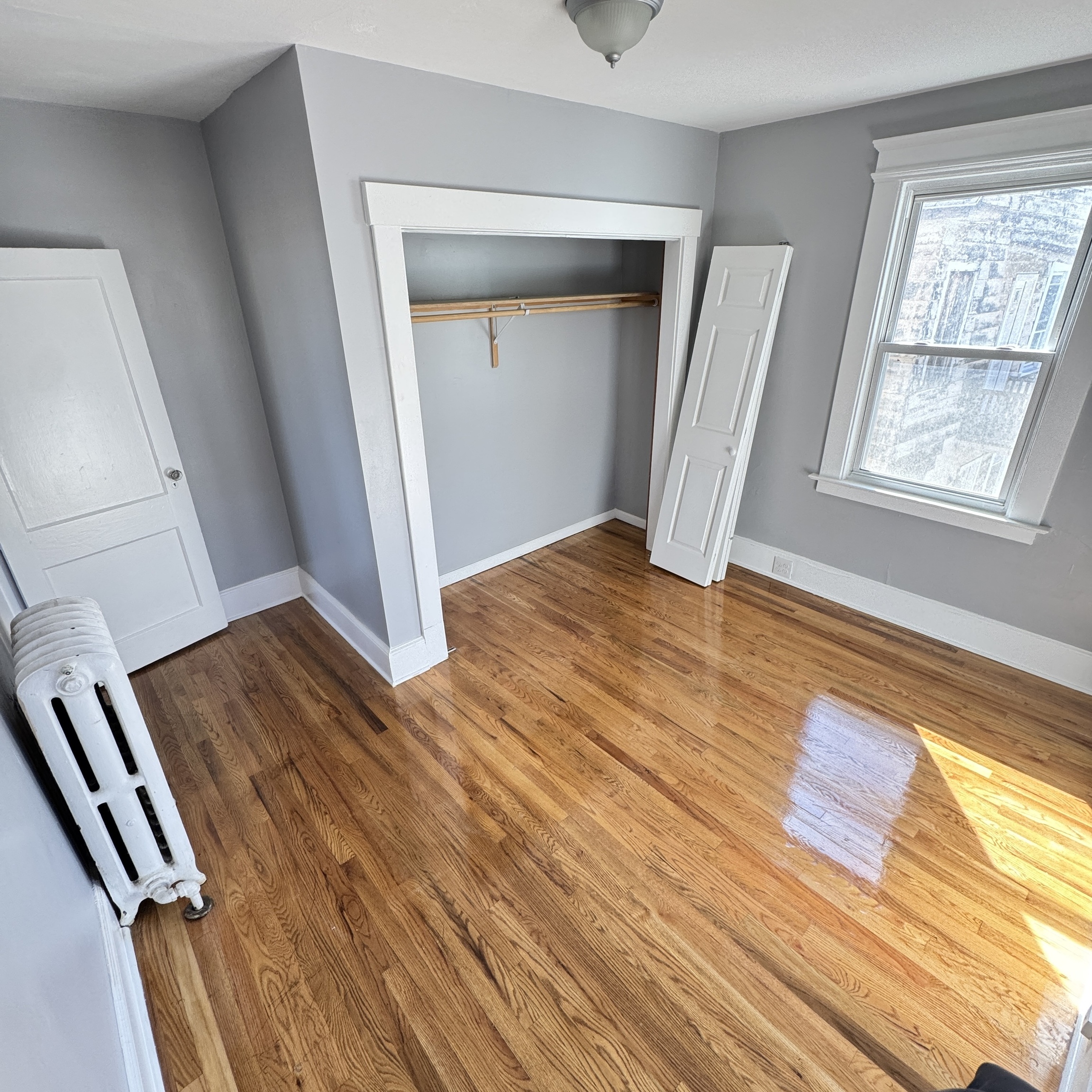 1528 Dixwell Avenue, Unit 2 Hamden, CT 06514 - Photo 5 of 11 a view of an empty room with wooden floor and a window