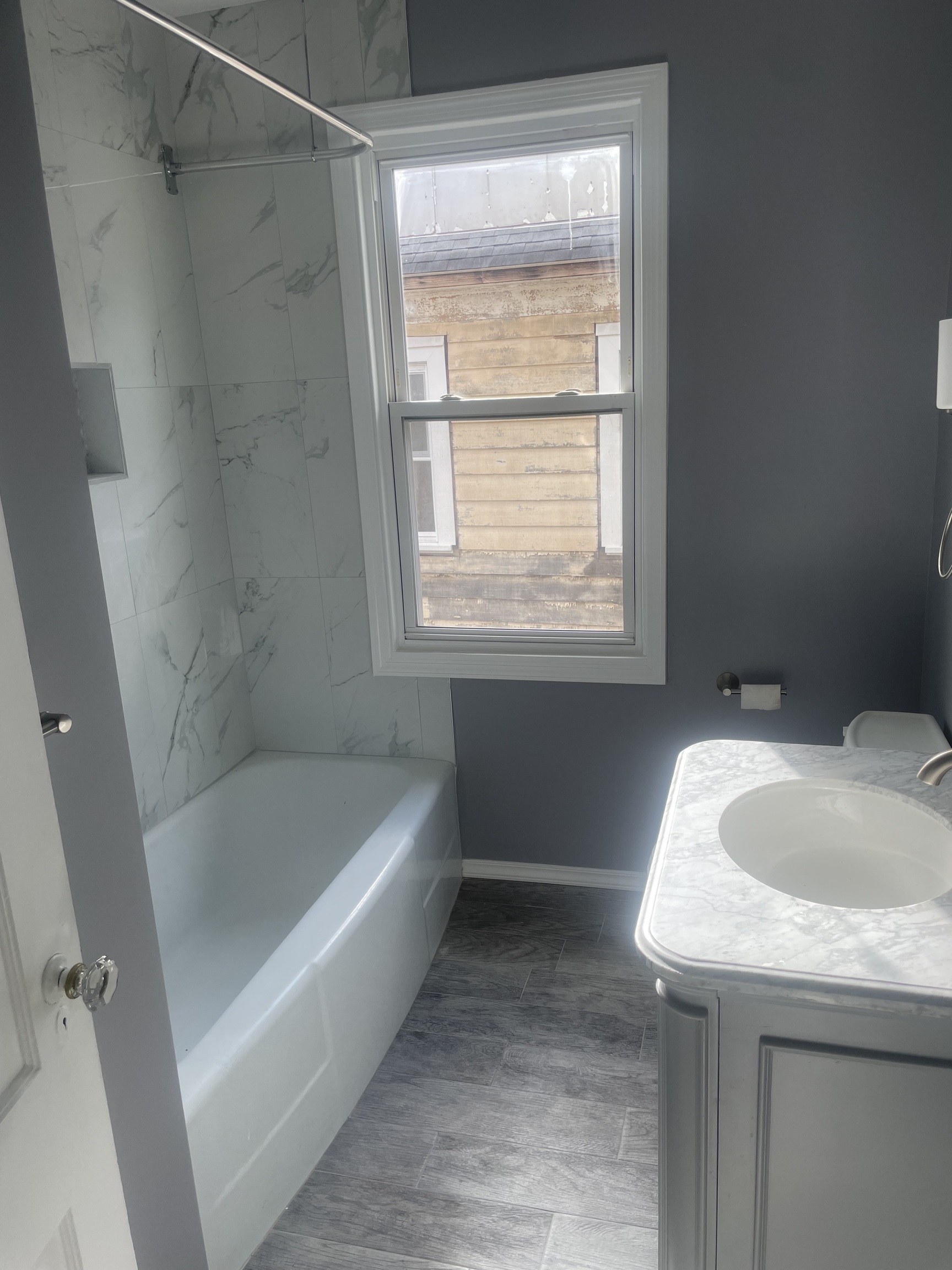 1528 Dixwell Avenue, Unit 2 Hamden, CT 06514 - Photo 6 of 11 a bathroom with a granite countertop sink a bathtub and shower