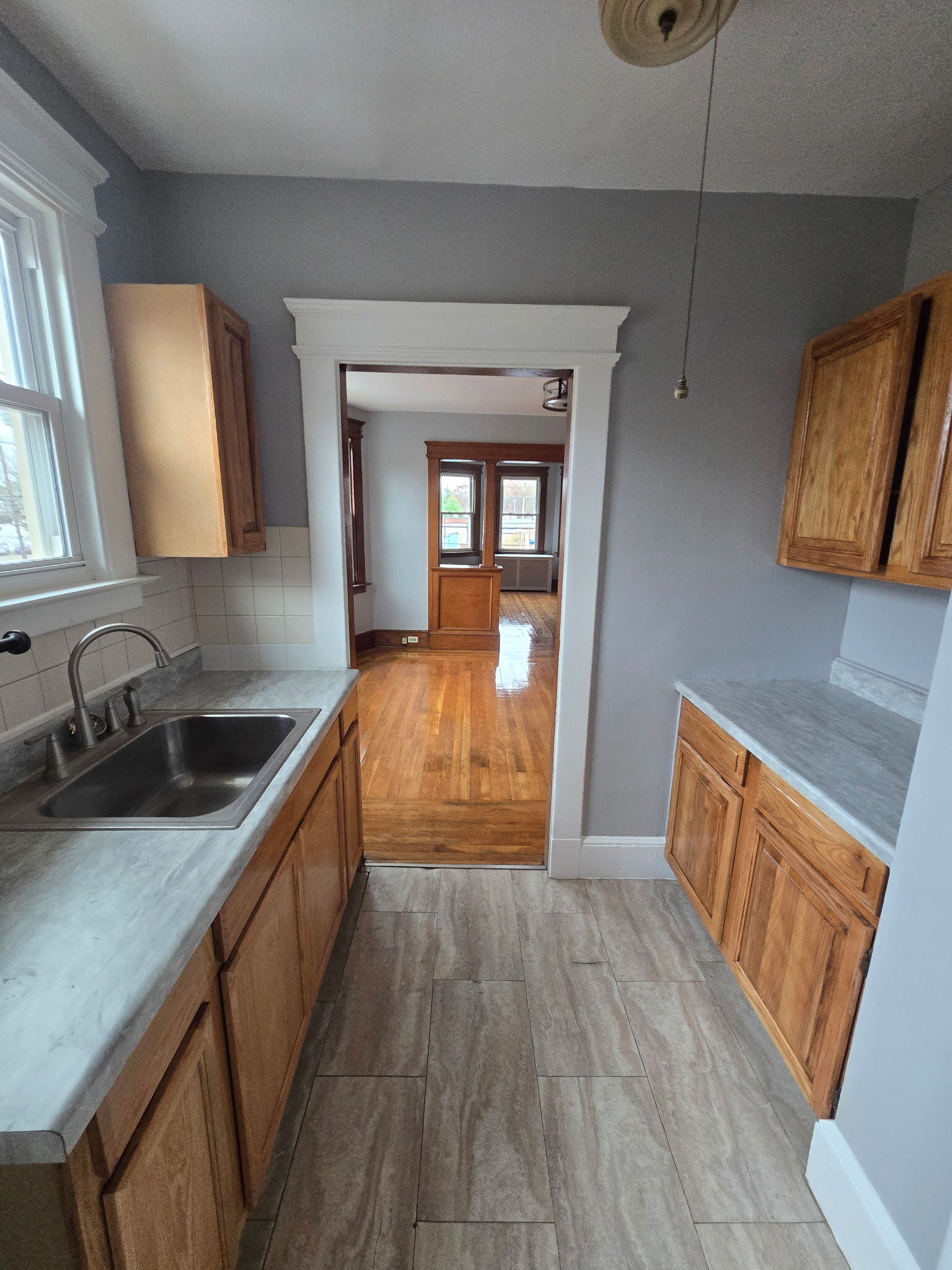 1528 Dixwell Avenue, Unit 2 Hamden, CT 06514 - Photo 9 of 11 a kitchen with granite countertop wooden floors a sink and a stove