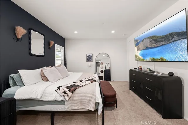 a bedroom with a bed and dresser