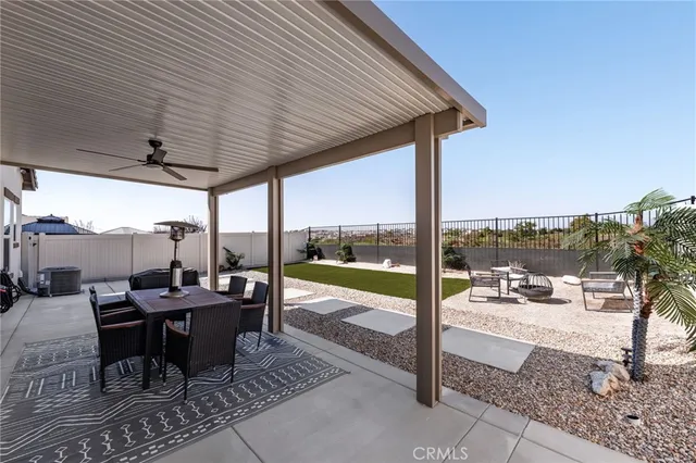 a view of a patio with a table chairs and backyard