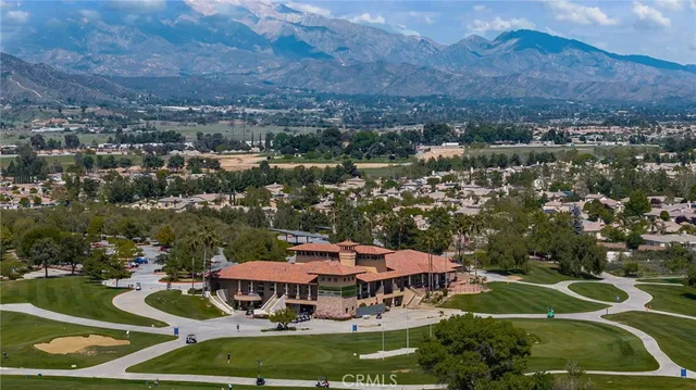 an aerial view of a house with a mountain
