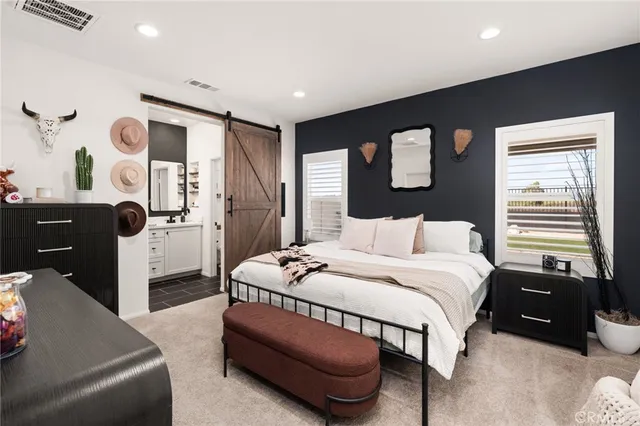 a bedroom with a bed couch and window