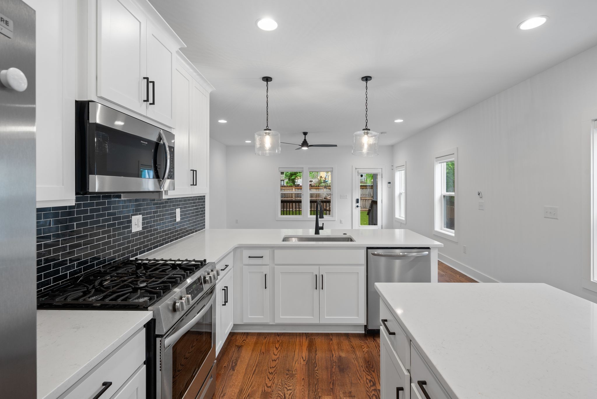 1305 A Lischey Avenue Nashville, TN 37207 - Photo 12 of 30 a kitchen that has a sink a stove and wooden floor