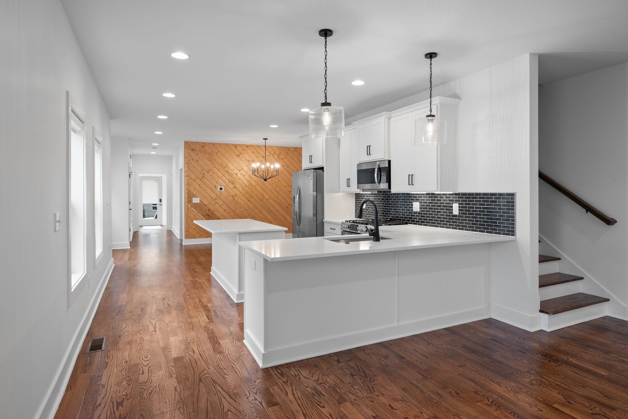 1305 A Lischey Avenue Nashville, TN 37207 - Photo 14 of 30 a view of a kitchen with kitchen island a sink wooden floor and a large window