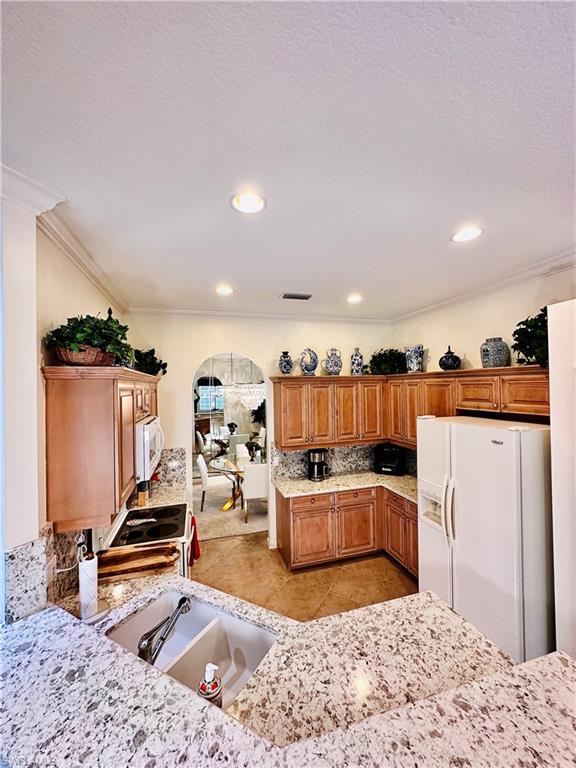 16152 Parque Lane Naples, FL 34110 - Photo 11 of 49 Kitchen with light tile patterned flooring, sink, white appliances, and ornamental molding