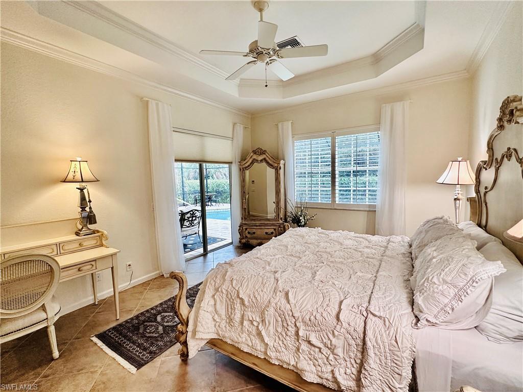 16152 Parque Lane Naples, FL 34110 - Photo 15 of 49 Tiled bedroom with a raised ceiling, access to outside, ornamental molding, and ceiling fan