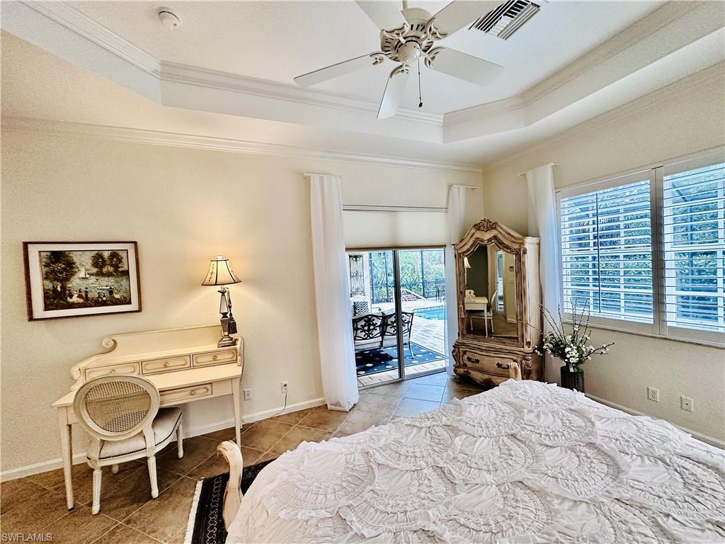 16152 Parque Lane Naples, FL 34110 - Photo 16 of 49 Bedroom with a raised ceiling, access to outside, light tile patterned floors, and ceiling fan