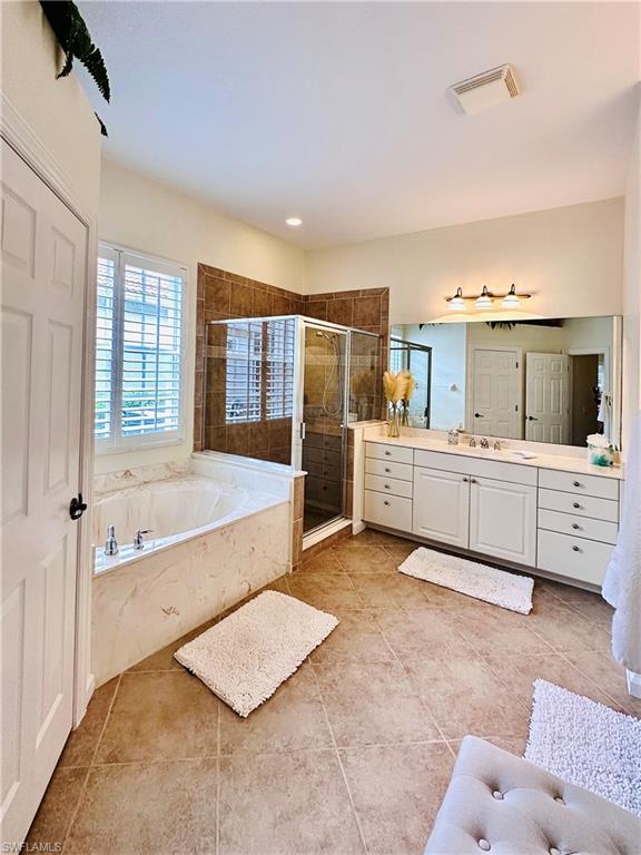 16152 Parque Lane Naples, FL 34110 - Photo 17 of 49 Bathroom with vanity, plus walk in shower, and tile patterned floors