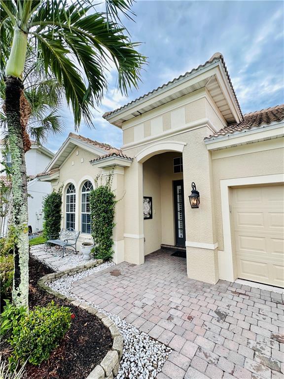 16152 Parque Lane Naples, FL 34110 - Photo 2 of 49 Mediterranean / spanish-style house featuring a garage