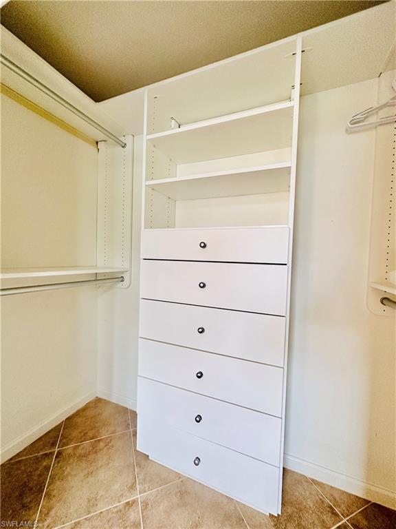16152 Parque Lane Naples, FL 34110 - Photo 22 of 49 Spacious master closet with light tile patterned floors