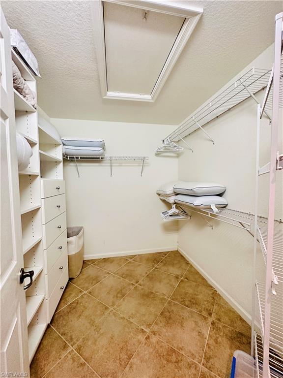 16152 Parque Lane Naples, FL 34110 - Photo 23 of 49 Walk in master closet featuring light tile patterned flooring