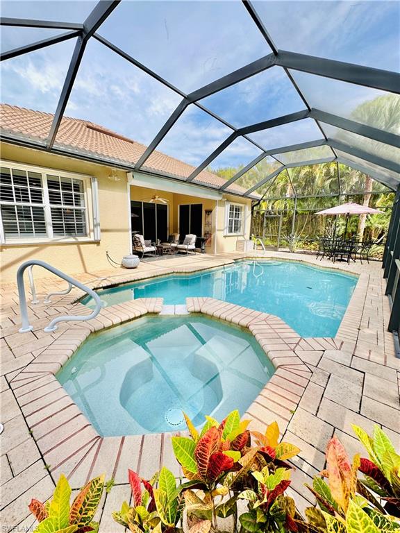 16152 Parque Lane Naples, FL 34110 - Photo 30 of 49 View of swimming pool with an in ground hot tub, a patio, and a lanai