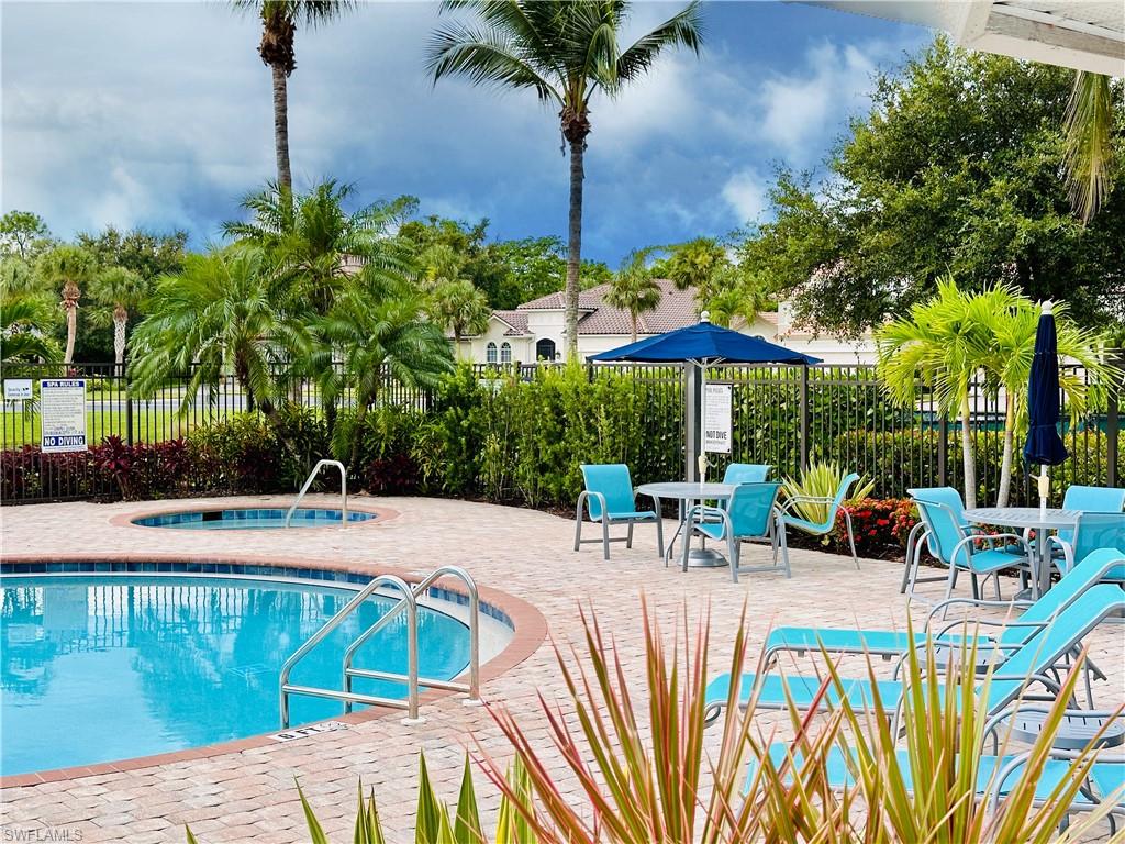 16152 Parque Lane Naples, FL 34110 - Photo 41 of 49 Clubhouse swimming pool with a hot tub and a patio area