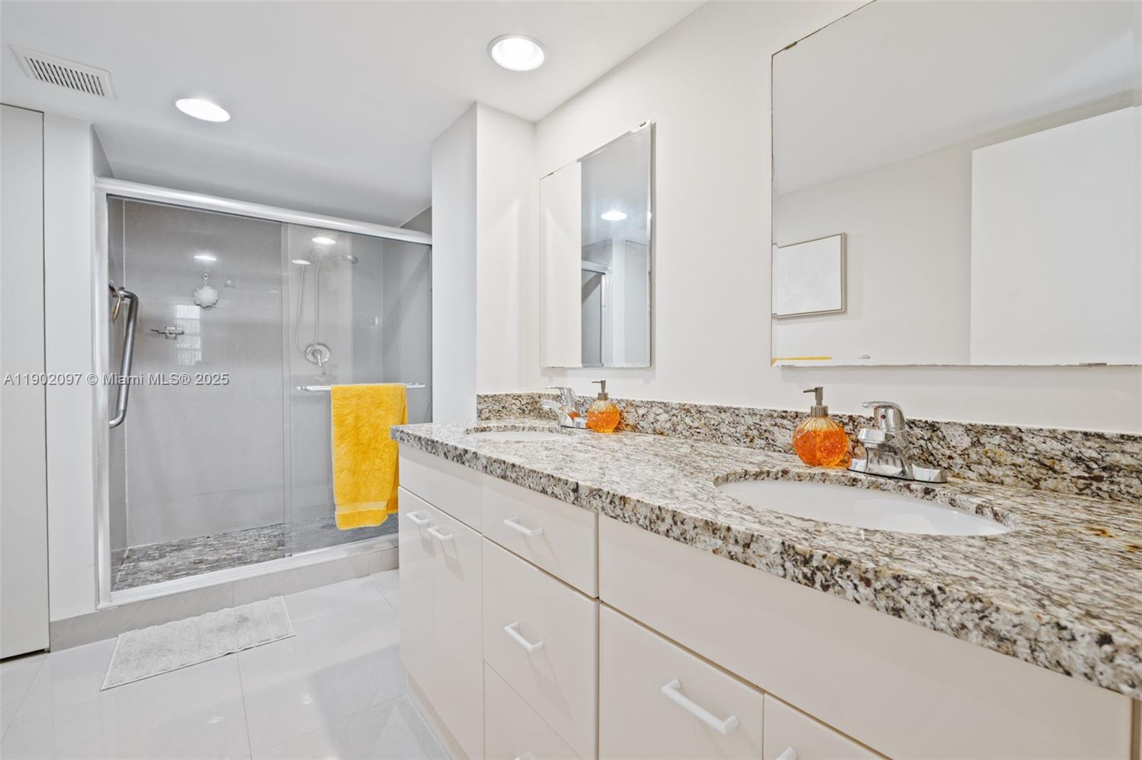 1833 South Ocean Drive, Unit 809 Hallandale Beach, FL 33009 - Photo 16 of 26 a bathroom with a tub sink and a mirror