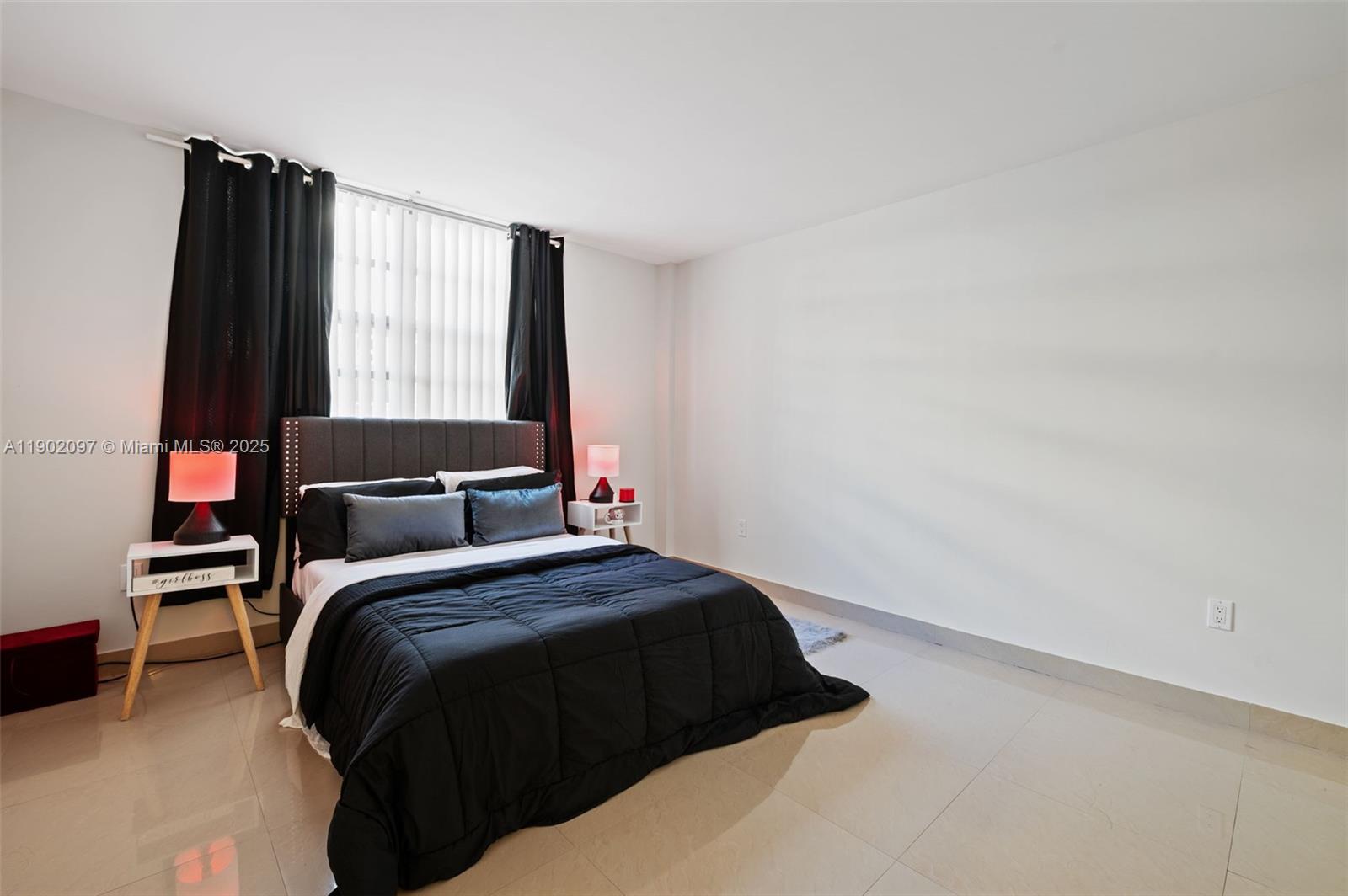 1833 South Ocean Drive, Unit 809 Hallandale Beach, FL 33009 - Photo 18 of 26 a bedroom with a bed and a window