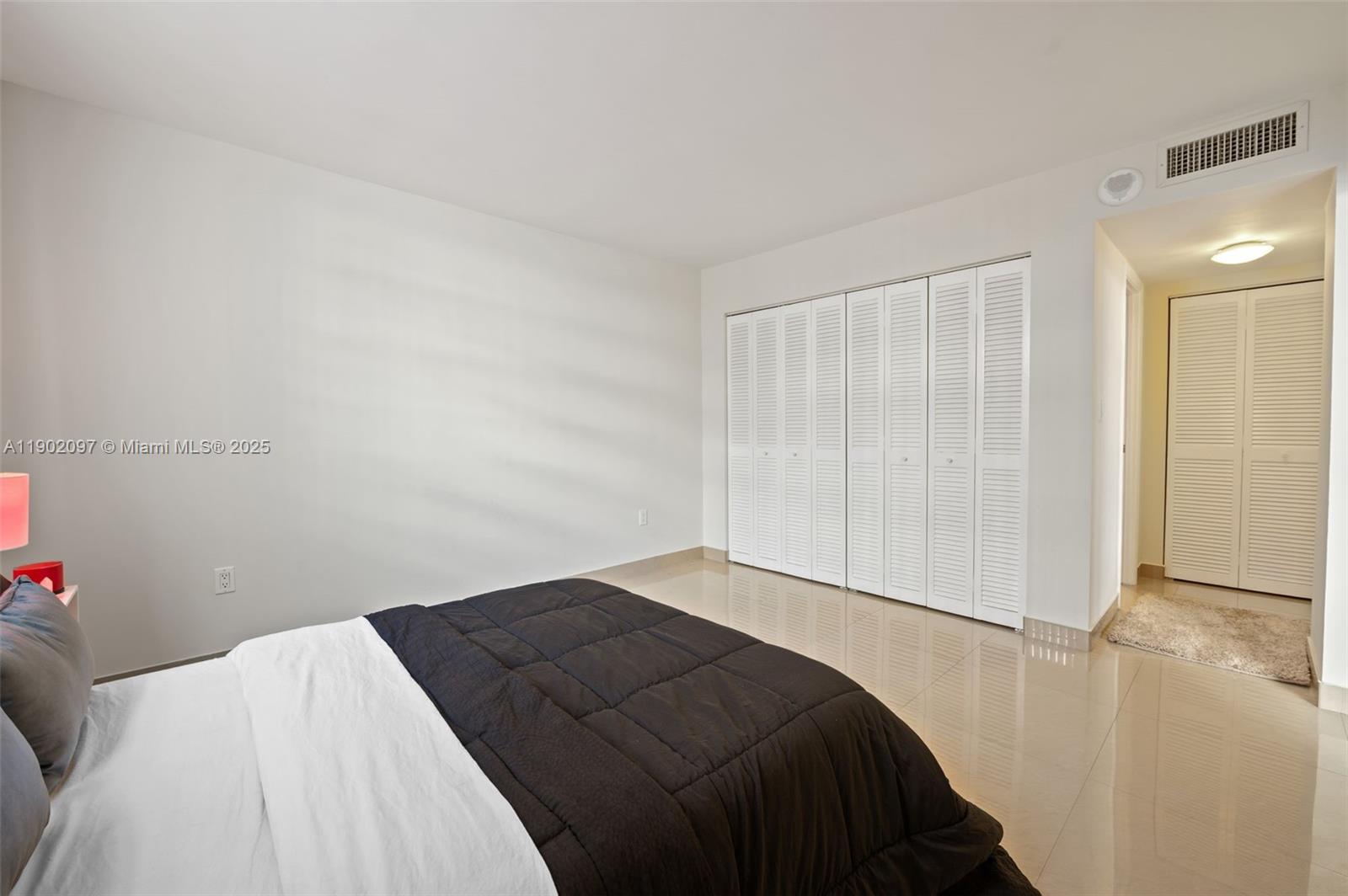 1833 South Ocean Drive, Unit 809 Hallandale Beach, FL 33009 - Photo 19 of 26 a bedroom with a bed and a hallway