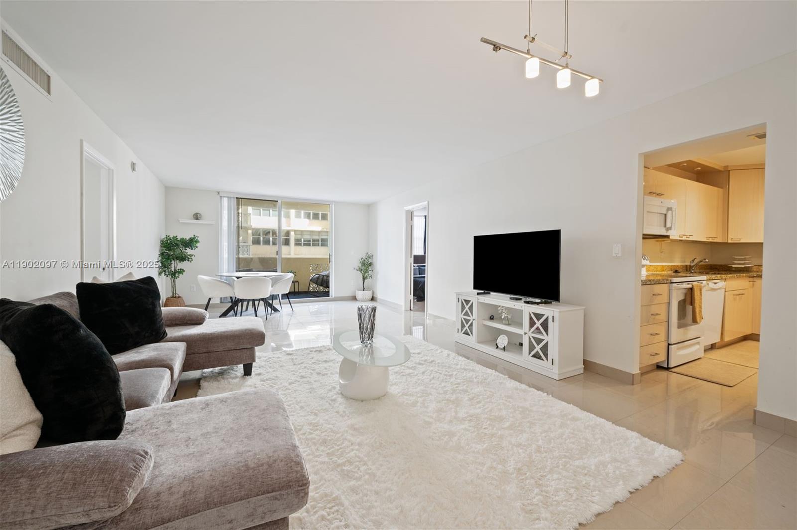 1833 South Ocean Drive, Unit 809 Hallandale Beach, FL 33009 - Photo 5 of 26 a living room with furniture and a flat screen tv