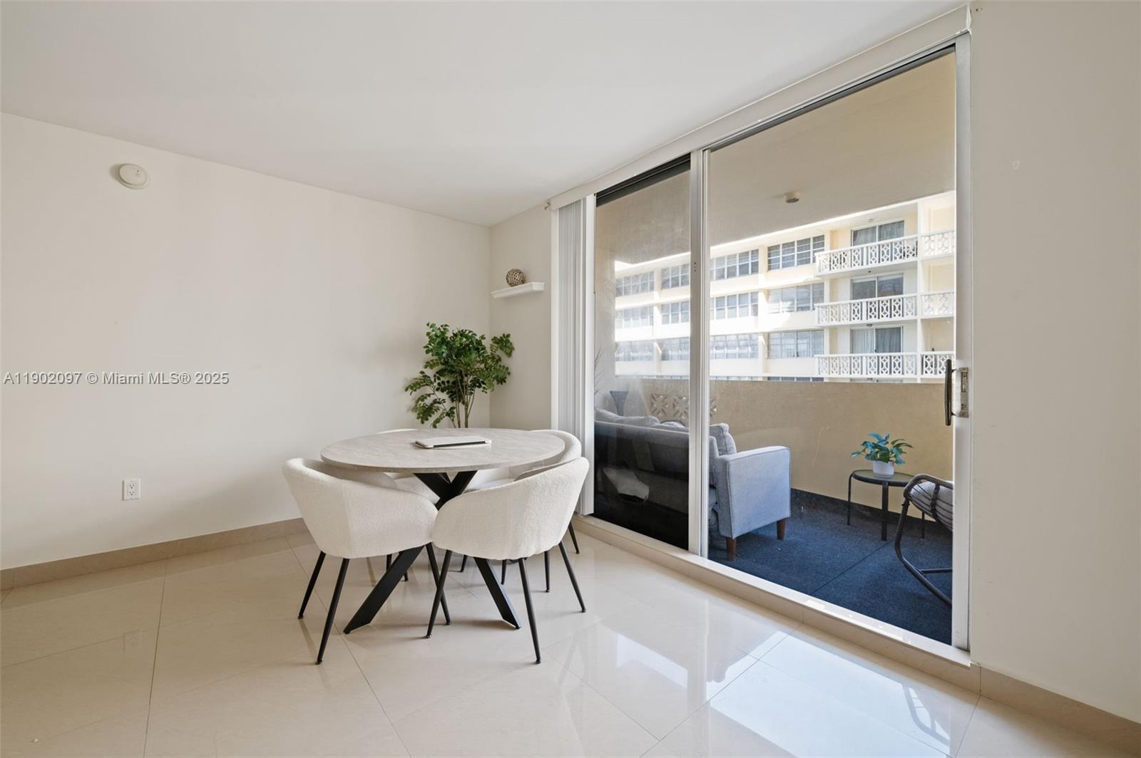 1833 South Ocean Drive, Unit 809 Hallandale Beach, FL 33009 - Photo 9 of 26 a view of a dining room with furniture window and wooden floor