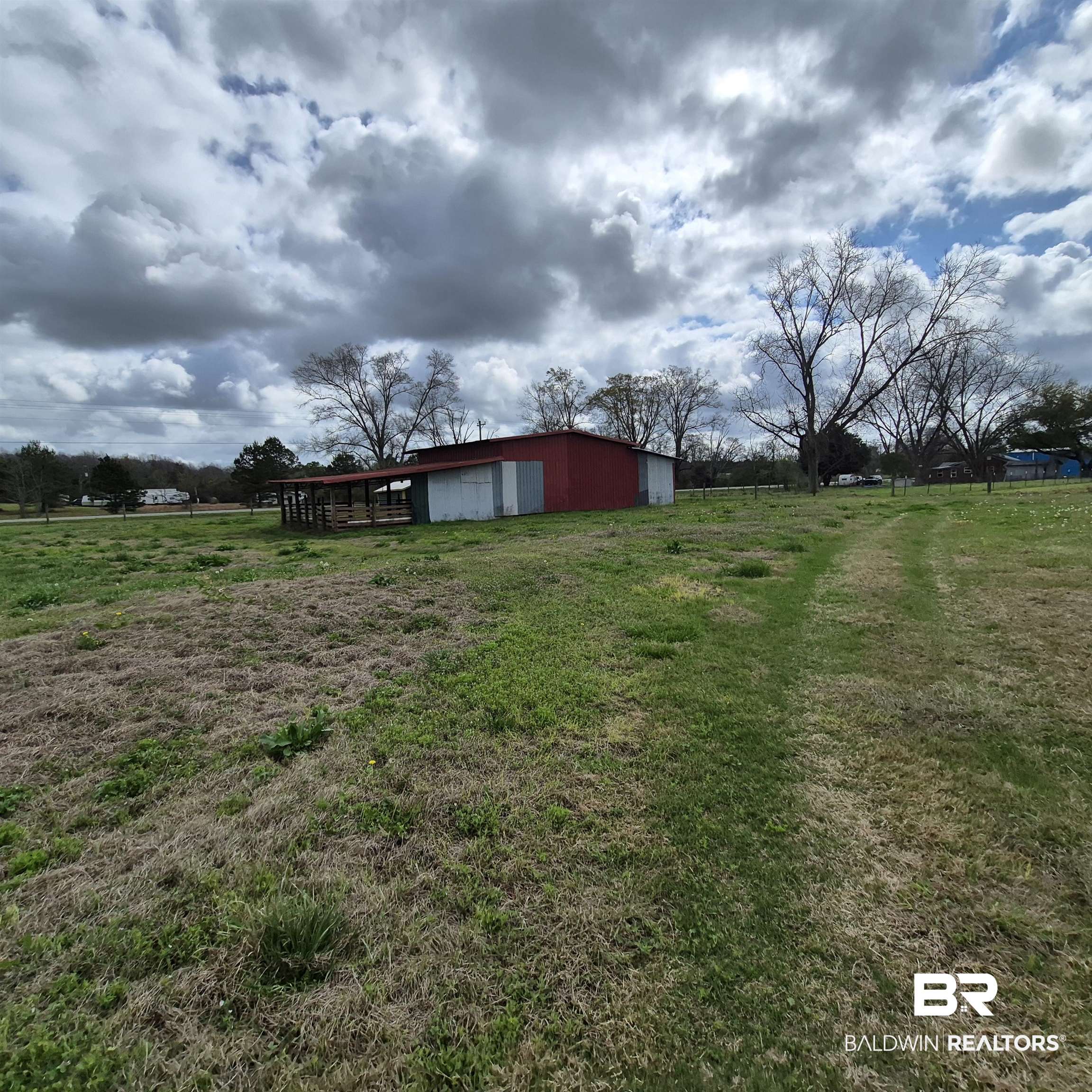 26635 Highway 41 Range, AL 36473 - Photo 68 of 74 View of green lawn with an outdoor structure, a pole building, a view of countryside, and a garage