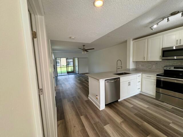 3939 Northeast 5th Avenue, Unit B102 Boca Raton, FL 33431 - Photo 2 of 20 a kitchen with granite countertop white cabinets and white appliances