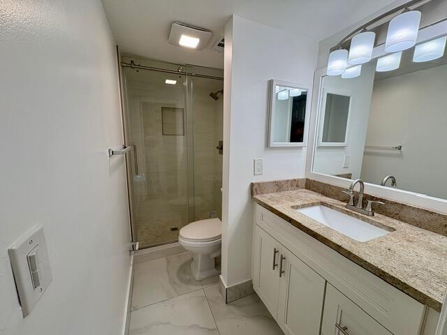 3939 Northeast 5th Avenue, Unit B102 Boca Raton, FL 33431 - Photo 8 of 20 a bathroom with a granite countertop sink toilet and shower