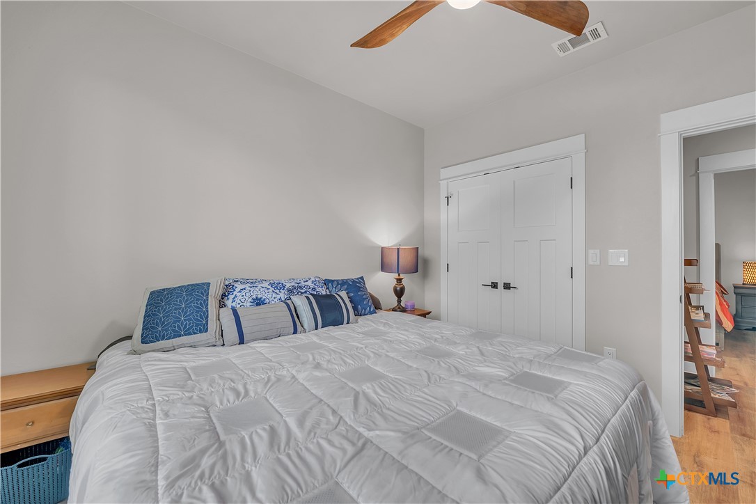 1601 Badger Lane Lampasas, TX 76550 - Photo 16 of 29 a bedroom with a bed and a chandelier fan