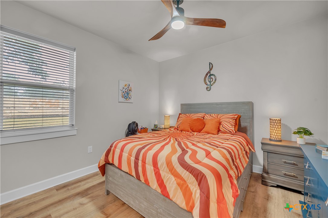 1601 Badger Lane Lampasas, TX 76550 - Photo 18 of 29 a bedroom with a bed and wooden floor