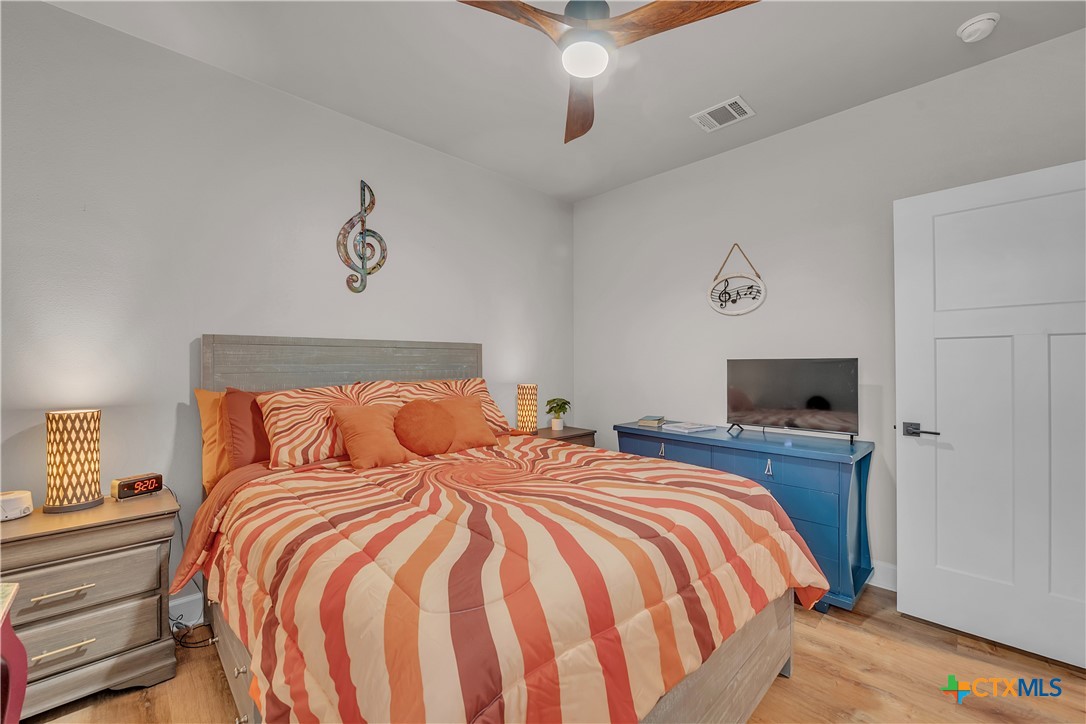 1601 Badger Lane Lampasas, TX 76550 - Photo 19 of 29 a bedroom with a bed and a flat screen tv