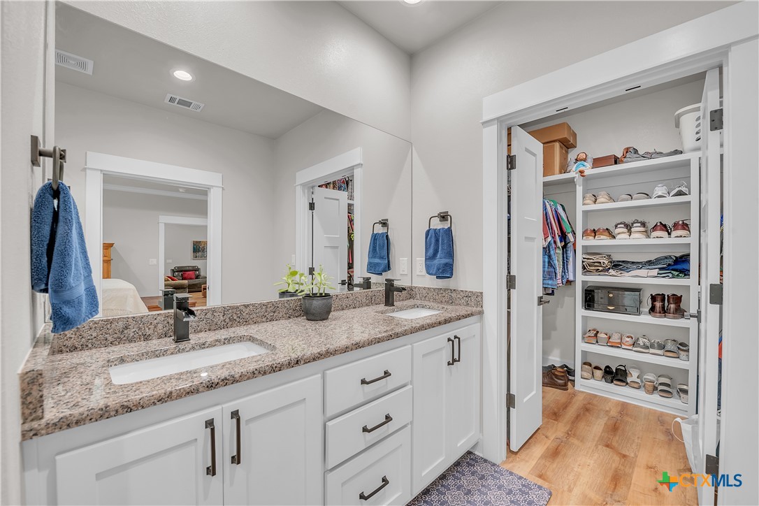 1601 Badger Lane Lampasas, TX 76550 - Photo 23 of 29 a bathroom with a granite countertop sink and a mirror