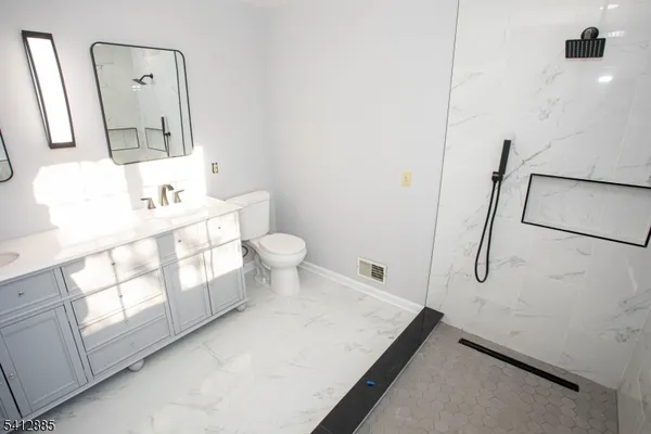 a bathroom with a sink toilet and mirror