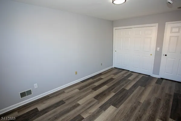 a view of room with wooden floor and window